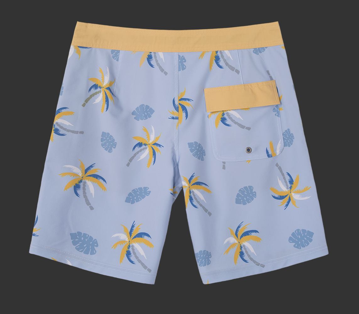 Blue shorts with palm tree pattern on a gray background