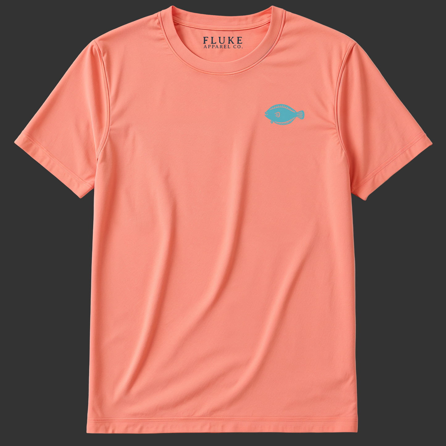 Coral t-shirt with a small blue fish logo on a white background