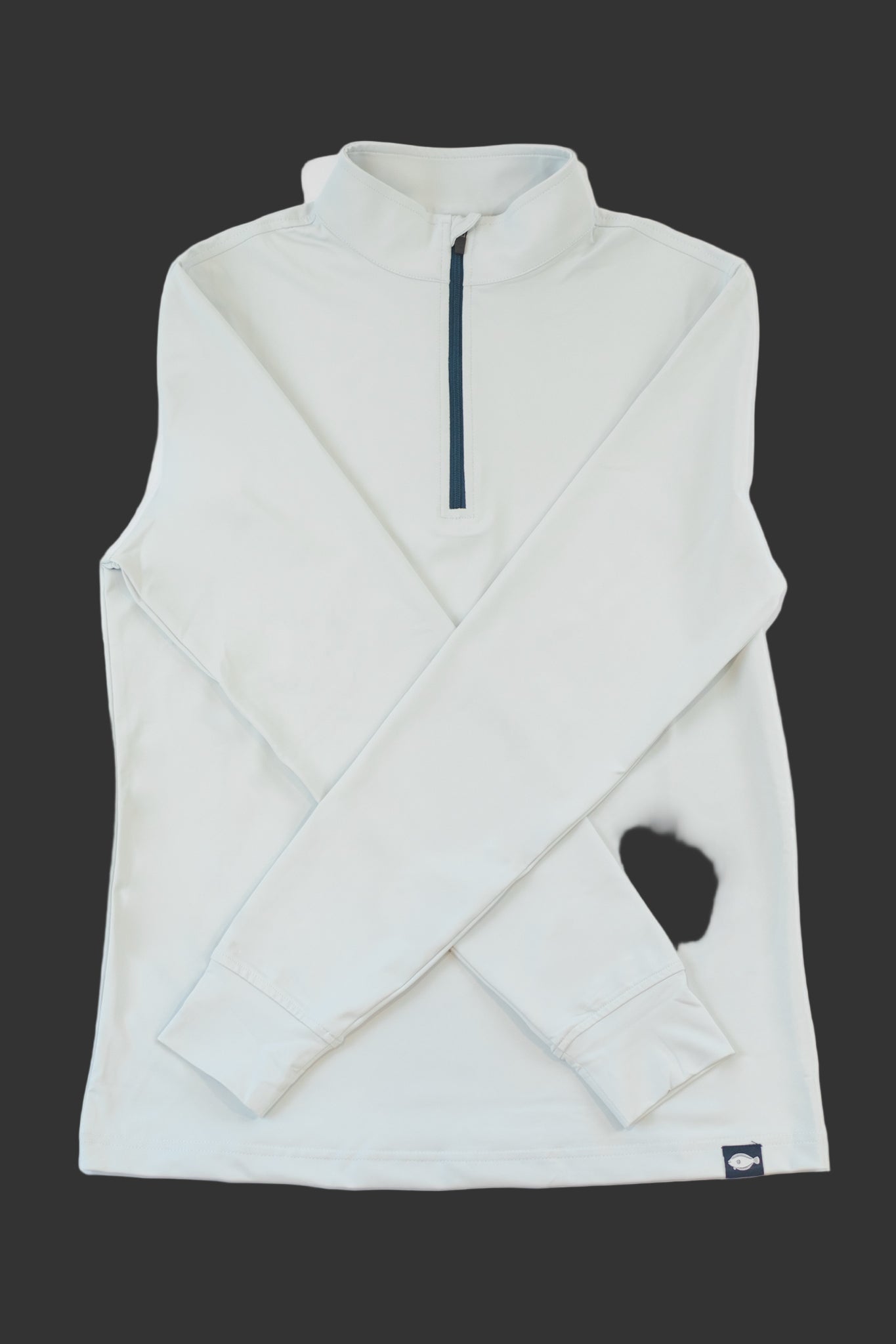 Light gray sleeveless jacket with a quarter zip on a Dark  background