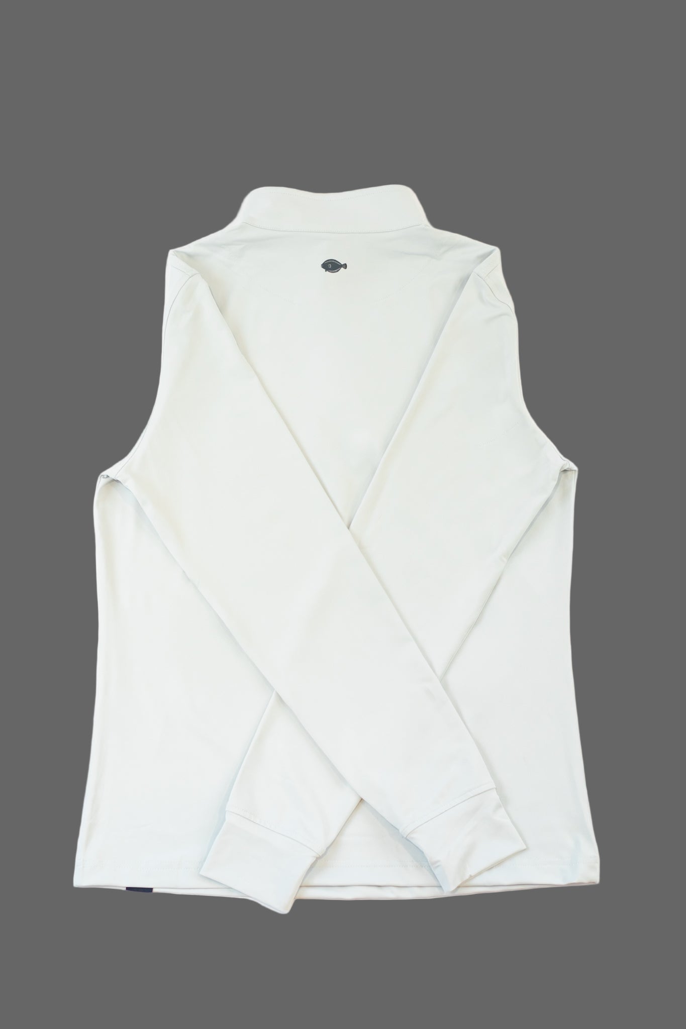 Folded white towel with a small black logo on a light gray background