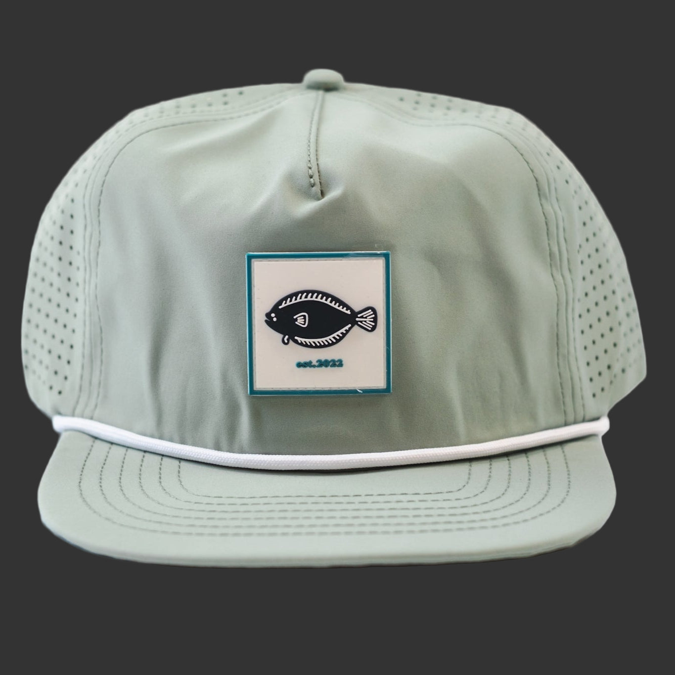 Light green cap with a fish logo patch on a Dark Blue background