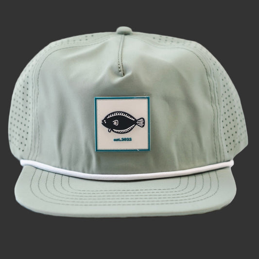 Light green cap with a fish logo patch on a Dark Blue background
