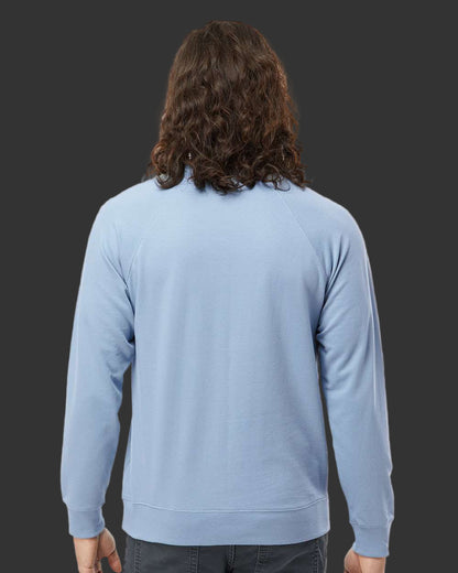 Person wearing a light blue sweater on a gray background
