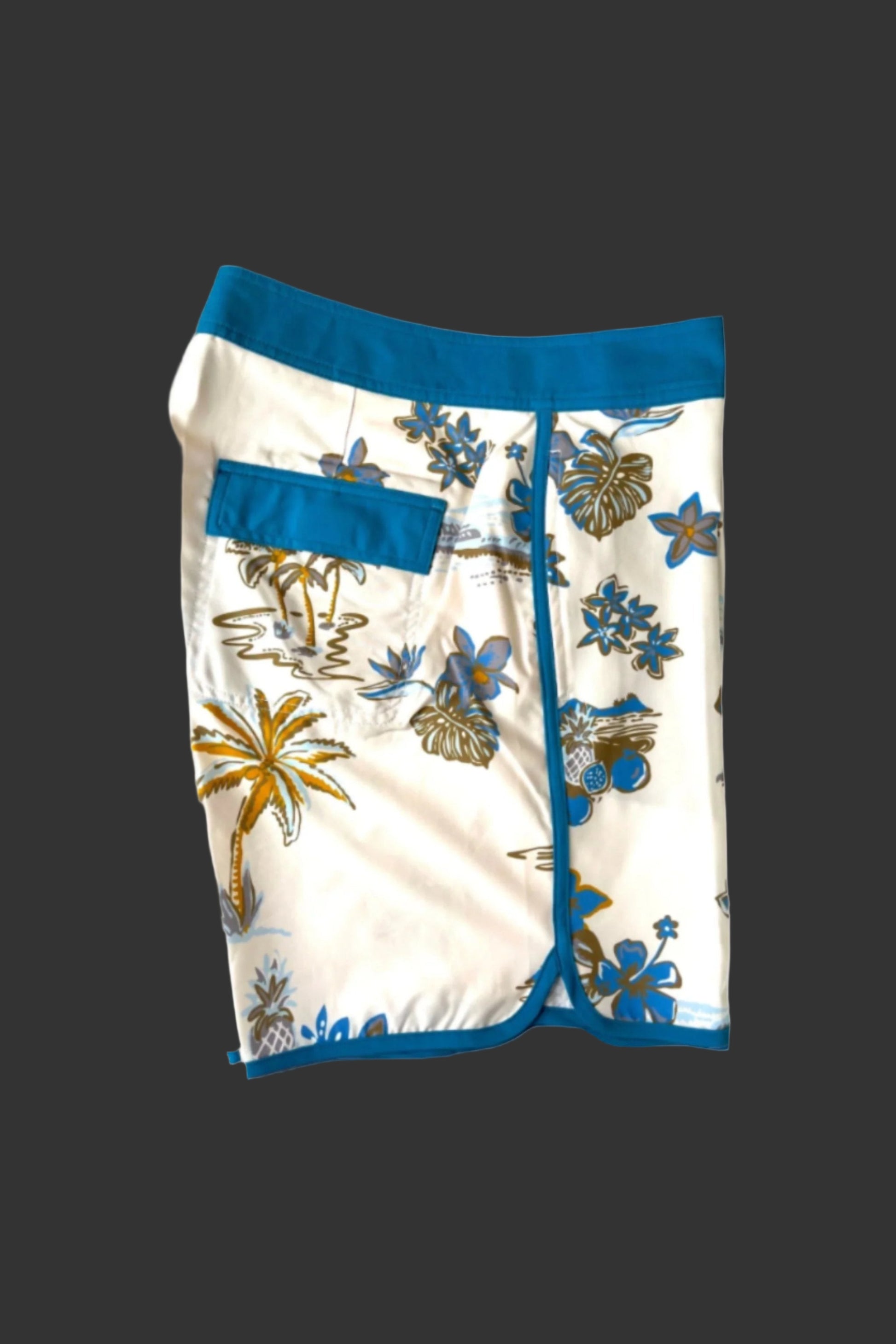 Beach shorts with tropical pattern on a light gray background